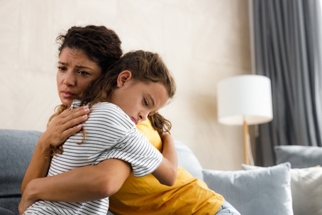 mother comforting daughter