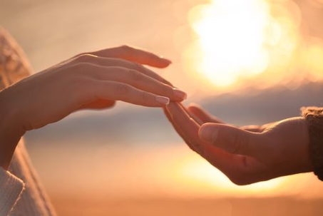 man and woman touching hands